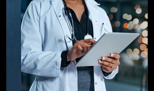 Doctor looking at iPad