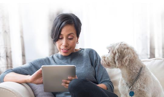 Woman with tablet and dog