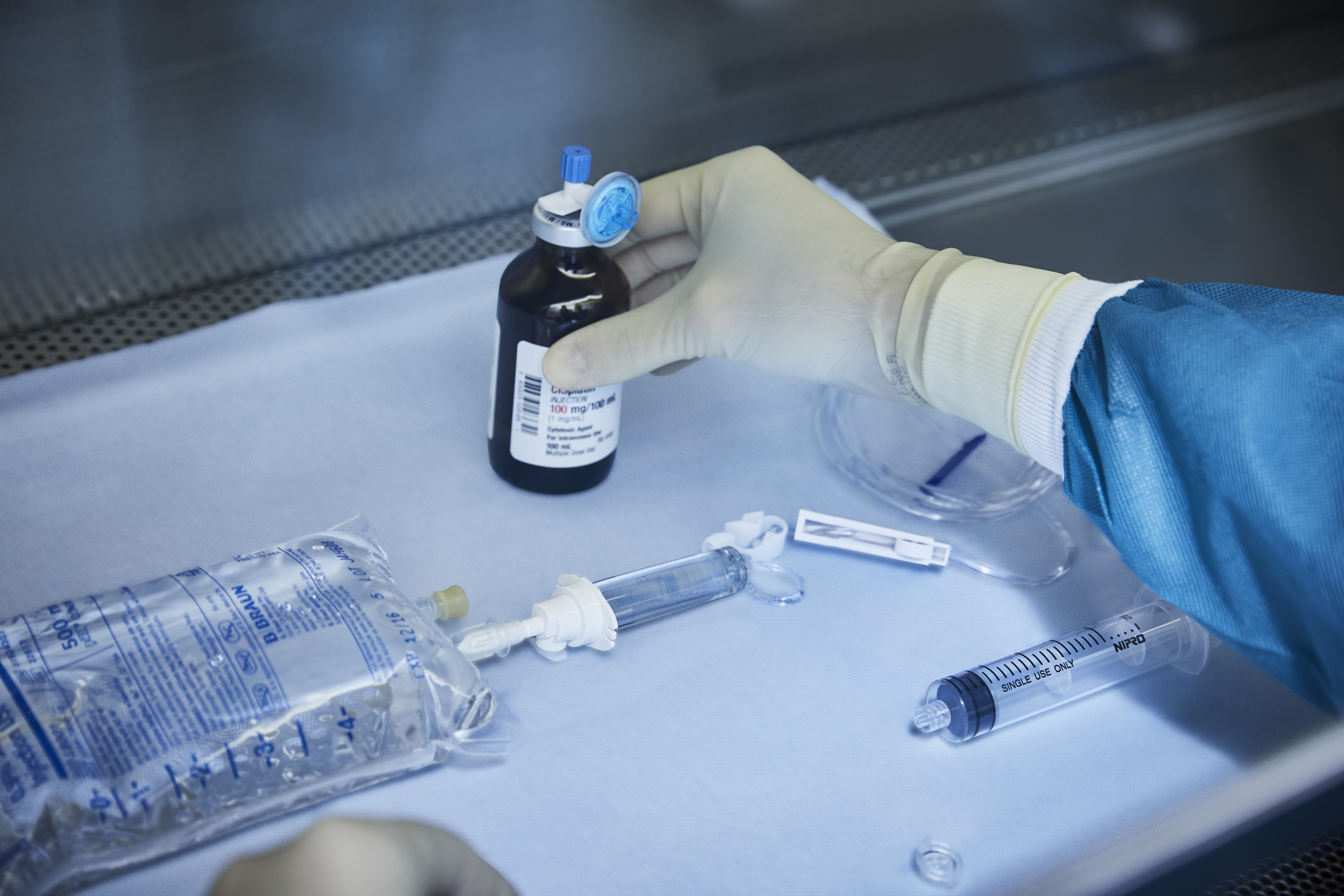 Gloved hand holding pharmaceuticals
